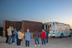 Group Standing by Ambulance