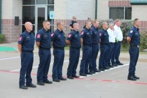 Firefighters standing at attention