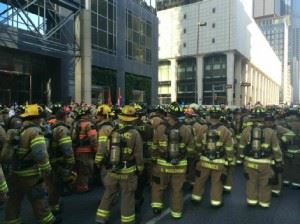 Firefighters standing outside of buildings