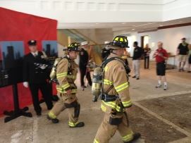 Uniformed firefighters walking